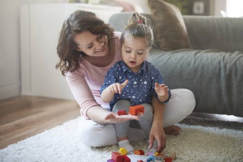 Mother and daughter playing with toys